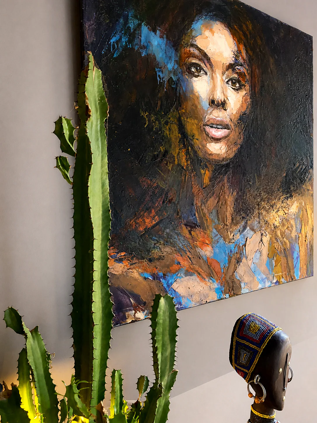 Portrait peint, cactus et sculpture perlée